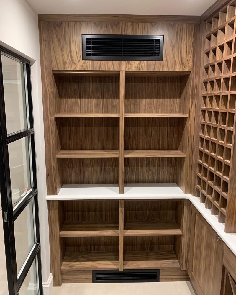 An image of a natural walnut wine room handcrafted by Colebarn Interiors, Derbyshire.
